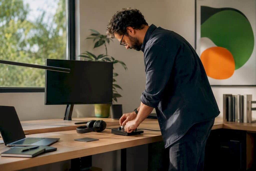 Hands adjusting color calibration tool on desk
