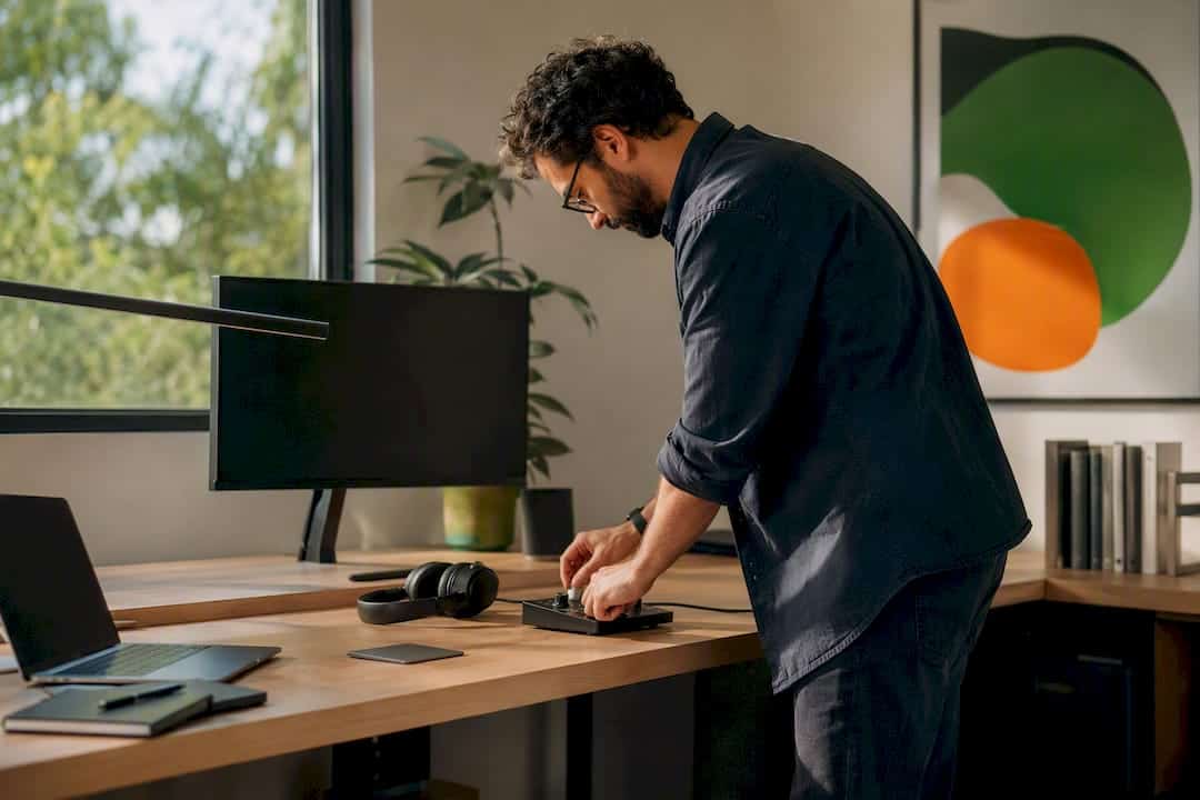 Hands adjusting color calibration tool on desk